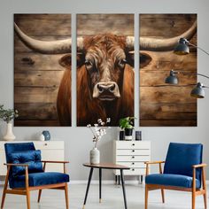 three paintings of cows are hanging on the wall in a living room with blue chairs