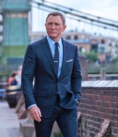 a man in a suit and tie standing on the sidewalk