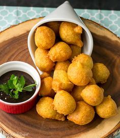 some food is sitting on a plate with dipping sauce