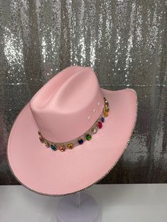 The “Rife” is named after blogger and influencer Whitney Rife (Instagram @Whitneyrife) - Nearly 60 gems are added to this hat all over the bottom brim and around the hat band to create a truly unique hat that no one else will have. This hat features: Pink straw hat Ab rhinestones on the underneath brim + ab hat band & ab rhinestone trim OPTION to have ab rhinestones on both brims + ab hat band Colorful gems with gold plating placed all over the bottom brim + around the crystal hat band Sizing: O Pink Wide Brim Hat For Rodeo, Bohemian Pink Hat Band With Curved Brim, Pink Brimmed Hat For Rodeo, Pink Rhinestone Cowgirl Hat, Crystal Hat, Rhinestone Trim, Unique Hats, Wearing A Hat