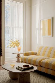 a living room with yellow and white furniture