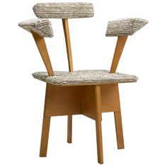 a chair with two wooden legs and an upholstered seat on the back side