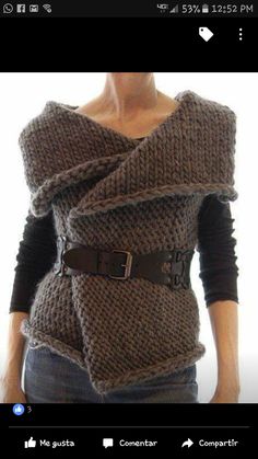 a mannequin wearing a knitted sweater with a belt around it's waist