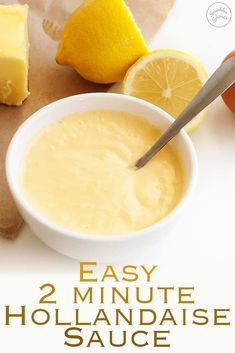 an easy 2 minute hollandaise sauce in a white bowl next to sliced lemons