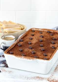 a pan filled with chocolate cake next to some cookies