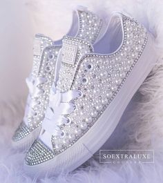 a pair of white sneakers with bows and pearls on the soles are shown in this instagram