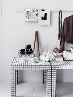 a white table topped with books and cups