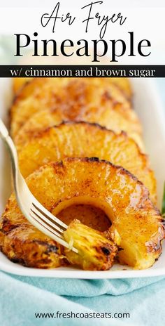 grilled pineapple with cinnamon and brown sugar in a white dish on a blue cloth