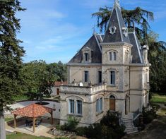 an old castle like building with a clock on it's roof and steeple