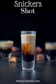 a shot glass filled with liquid sitting on top of a table