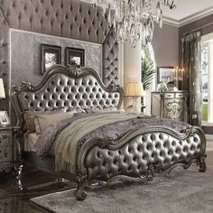 a bedroom with an ornate bed and chandelier