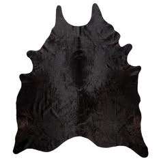 a black and brown cowhide rug on a white background with the top half showing