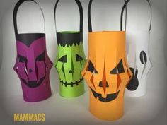 four different colored paper bags with faces on them and one has a trick bag in the shape of a jack - o'- lantern