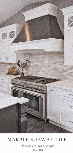 a stove top oven sitting inside of a kitchen next to white cabinets and counter tops