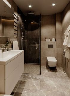 a bathroom with a sink, toilet and shower