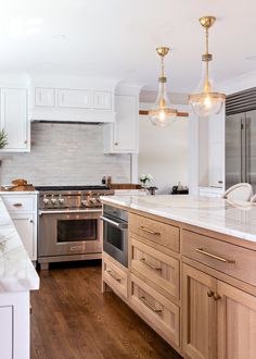 a kitchen with an oven, stove and sink in it's center island area