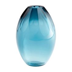 a blue glass vase sitting on top of a white table