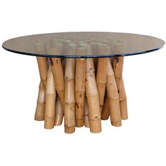 a glass table topped with lots of wooden sticks