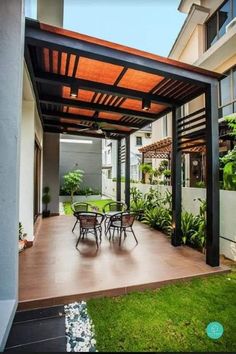 an outdoor covered patio with tables and chairs