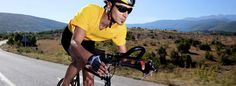 a man riding a bike down the side of a road