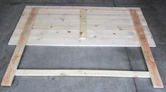 an unfinished bed frame sitting on the ground