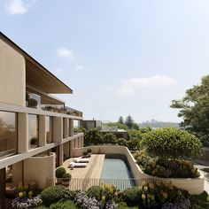 an outdoor swimming pool surrounded by plants and trees