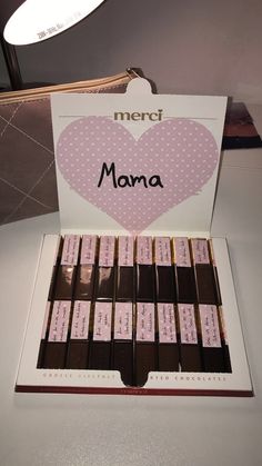 there is a box of chocolates with the word mama on it in pink and white