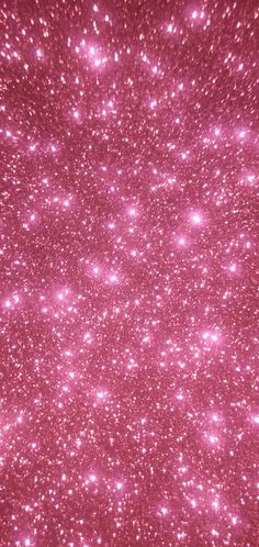 pink glitter sparkles in the air on a dark background