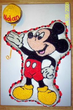 a mickey mouse cake with a lollipop