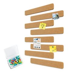 a group of wooden pegs sitting on top of a white table next to some magnets