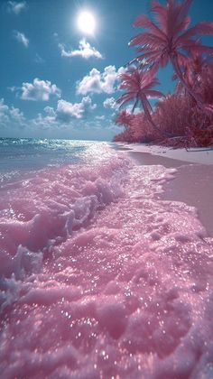 the beach is covered in pink sand and palm trees, under a full moonlit sky