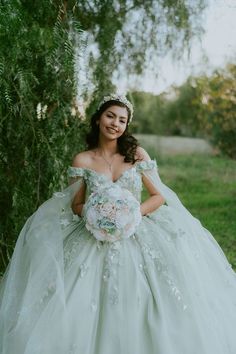 a woman in a wedding dress posing for the camera