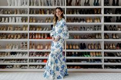 a woman standing in front of a rack of shoes