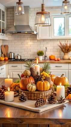 a table topped with candles and pumpkins on top of a wooden table next to an oven