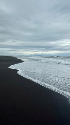 an ocean beach with waves coming in to shore