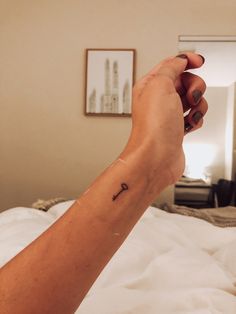 a person's arm with a small tattoo on the left side of their arm