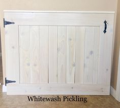 a white wood paneled wall with the words whitewash picking on it