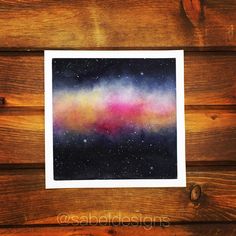 an image of a painting on wood with stars in the sky and pink and blue colors