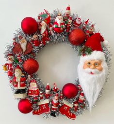 a christmas wreath with santa claus and other ornaments