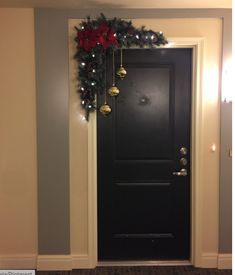 a black door with christmas decorations on it