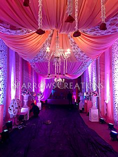 a purple and white wedding decorated with chandeliers