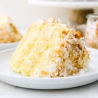 a piece of cake sitting on top of a white plate next to another slice of cake