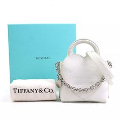 Auth Tiffany&Co. Return To Tiffany Handbag Crossbody Bag White/Silver Description This Is A Guaranteed Authentic Tiffany&Co. Return To Tiffany Crossbody Shoulder Bag. Please Check Photos Carefully Before Buying The Item. Brand Tiffany&Co. Style Crossbody Shoulder Bag Color White Material Leather Size [Inch] W:4.3inx H:3.9inx D:2.6in Handle Length:5.1in Shoulder Length: 40.9in Size [Cm] W:11cmx H:10cmx D:6.5cm Handle Length:13cm Shoulder Length: 104cm Specifications Magnet Button Closure Comes Wi Tiffany White, Return To Tiffany, Dust Cover, White Bag, White Material, Tiffany & Co., Shoulder Length, White Silver, Crossbody Shoulder Bag