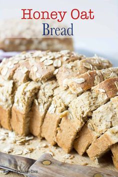 a loaf of oatmeal bread sitting on top of a cutting board next to a knife