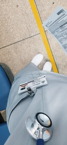 a doctor's stethoscope laying on the floor next to a blue chair