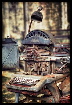 an old typewriter sitting on top of a wooden table