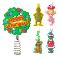 christmas ornaments are hanging from hooks on a white background with the words merry grinchmas