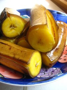 a blue plate topped with sliced bananas on top of a table