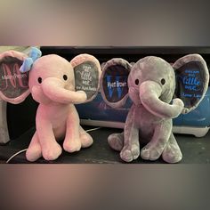 two stuffed elephants sitting next to each other