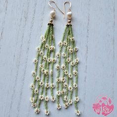 green beaded earrings with white flowers and pearls